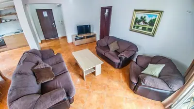 a living room with two chairs and a table at Villa Franeta Apartments in Budva