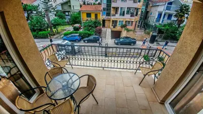 a balcony with a table and chairs and a street at Villa Franeta Apartments in Budva