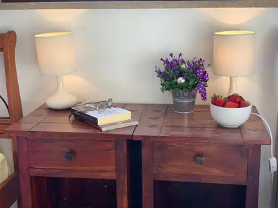 a table with two lamps and a bowl of fruit on it at Karina Apartment in Budva