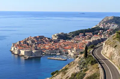 a view of a town on a hill next to the ocean at Karina Apartment in Budva