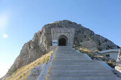 a stairway leading up to a mountain with a door at Karina Apartment in Budva
