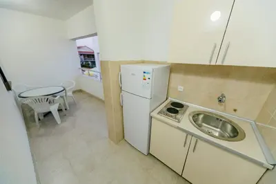 a kitchen with a sink and a washing machine at MC Apartments in Ulcinj