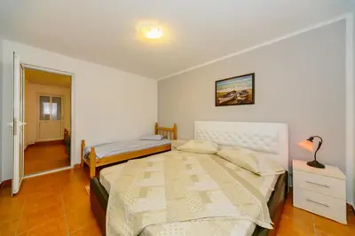 a bedroom with two beds and a lamp in it at MC Apartments in Ulcinj