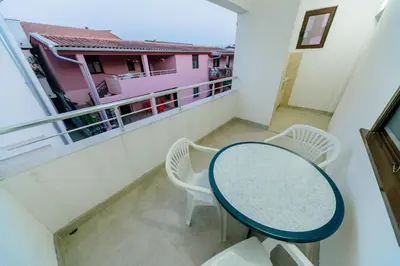 a table and chairs on a balcony with a view at MC Apartments in Ulcinj