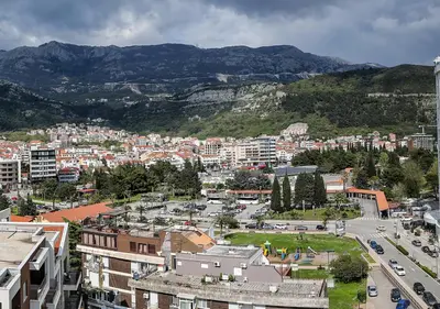 an aerial view of a city with buildings and mountains at Budva Bay Breeze Apartments in Budva