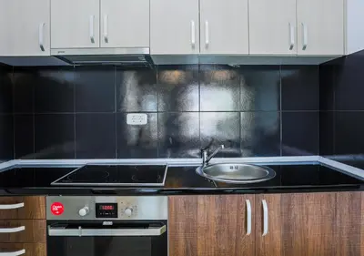 a kitchen with a sink and a stove at Budva Bay Breeze Apartments in Budva