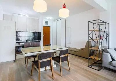 a kitchen and dining room with a table and chairs at Budva Bay Breeze Apartments in Budva
