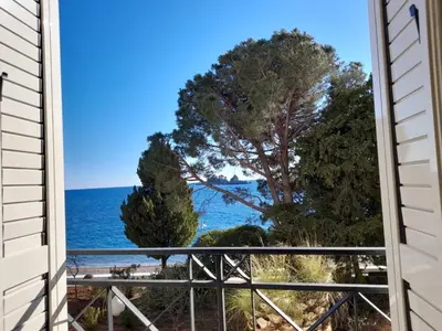 a view of the ocean from a house window at LuxBeachFront in Petrovac na Moru