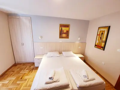 a bedroom with a bed with two towels on it at Apartments Pier in Budva