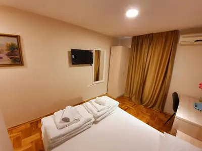 a hotel room with a bed with towels on it at Apartments Pier in Budva