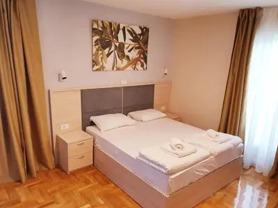 a bedroom with a bed with two towels on it at Apartments Pier in Budva