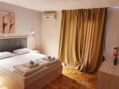 a bedroom with a bed with towels on it at Apartments Pier in Budva