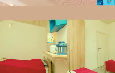 a room with a red bed and a red table at Beautiful Apartment In Utjeha in Utjeha