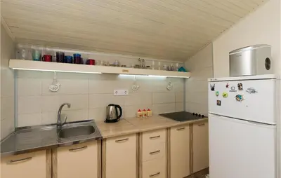 a kitchen with a sink and a white refrigerator at Beautiful Apartment In Utjeha in Utjeha