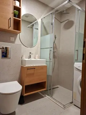 a bathroom with a sink and a shower at Pg Apartment in Podgorica
