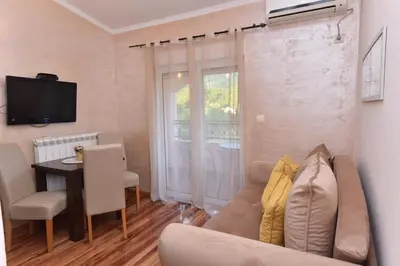 a living room with a couch and a table at Pejovic Residence Budva in Budva
