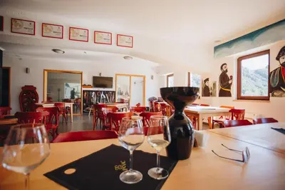 two wine glasses sitting on a table in a restaurant at Eco Winery Lipovac Apartments in Cetinje
