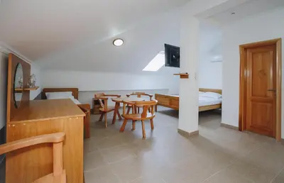 a living room with a table and chairs and a bedroom at Eco Winery Lipovac Apartments in Cetinje