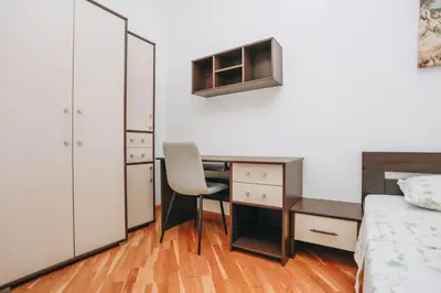 a bedroom with a desk and a bed at Apartment near Ponta Nova of Rafailovici in Becici