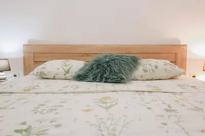 a stuffed animal sitting on top of a bed at Apartment near Ponta Nova of Rafailovici in Becici