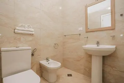a bathroom with a toilet and a sink and a mirror at Apartment near Ponta Nova of Rafailovici in Becici