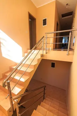 a staircase in a house with a metal railing at Villa Narcissus Montenegro KO Sveti Stefan in Sveti Stefan