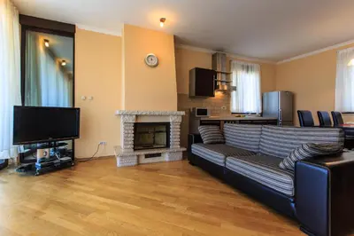 a living room with a couch and a fireplace at Villa Narcissus Montenegro KO Sveti Stefan in Sveti Stefan
