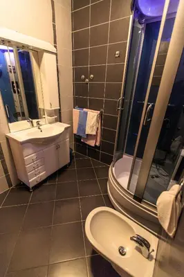 a bathroom with a sink and a toilet and a mirror at Villa Narcissus Montenegro KO Sveti Stefan in Sveti Stefan