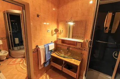 a bathroom with a sink and a toilet and a mirror at Villa Narcissus Montenegro KO Sveti Stefan in Sveti Stefan