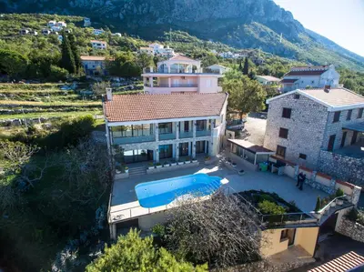 an aerial view of a house with a swimming pool at Villa Narcissus Montenegro KO Sveti Stefan in Sveti Stefan