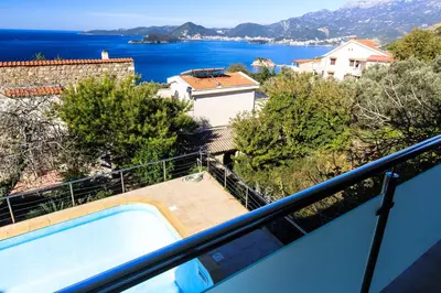 a view from the balcony of a house with a swimming pool at Villa Narcissus Montenegro KO Sveti Stefan in Sveti Stefan