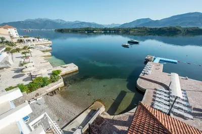 a view of a lake with a boat in the water at Apart-hotel Villa Lav in Tivat