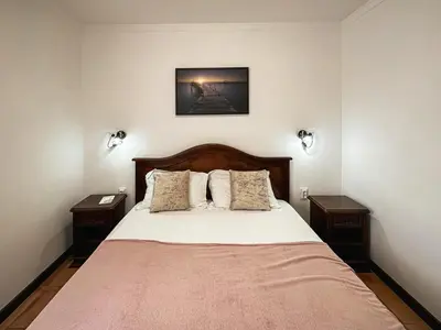 a bedroom with a large bed with two night stands at Apart-hotel Villa Lav in Tivat