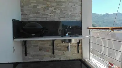 a sink in a room with a brick wall at Apartment-Hotel Vila Petrovic-Becici in Budva
