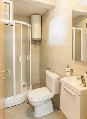 a bathroom with a toilet and a shower and a sink at Apartment-Hotel Vila Petrovic-Becici in Budva
