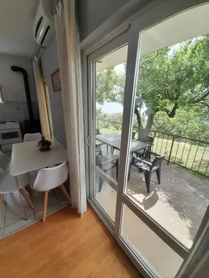 a room with a sliding glass door leading to a patio at Top see in Bar