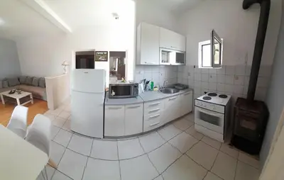 a kitchen with a white refrigerator and a stove at Top see in Bar