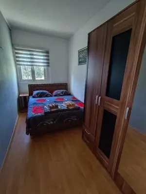 a bedroom with a bed and a wooden door at Top see in Bar