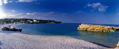 a beach with rocks in the water and the ocean at Top see in Bar