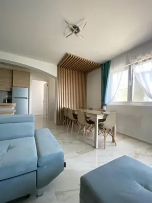 a living room with a blue couch and a table at B&T Apartments in Budva