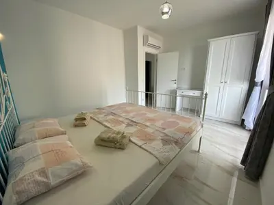 a bed with two pillows on it in a room at B&T Apartments in Budva