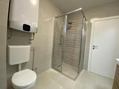 a bathroom with a shower and a toilet at B&T Apartments in Budva