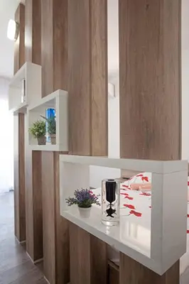 a white shelf with a glass of wine on it at B&T Apartments in Budva