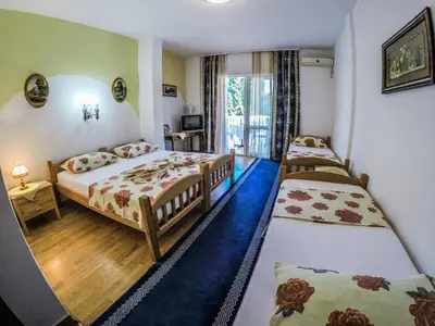 a hotel room with two beds and a television at Eldorado Apartments in Ulcinj