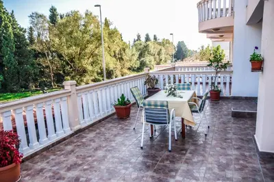 a patio with a table and chairs on a balcony at Eldorado Apartments in Ulcinj