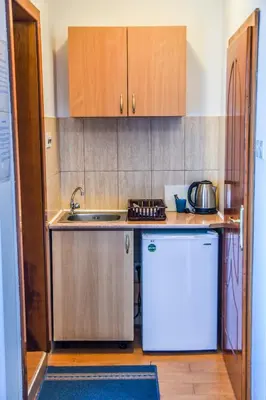 a small kitchen with a sink and a refrigerator at Eldorado Apartments in Ulcinj