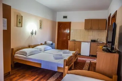 a bedroom with a bed and a kitchen at Eldorado Apartments in Ulcinj