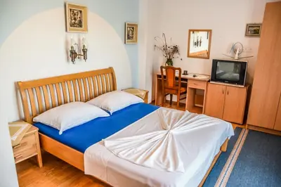a bedroom with a bed and a desk and a television at Eldorado Apartments in Ulcinj