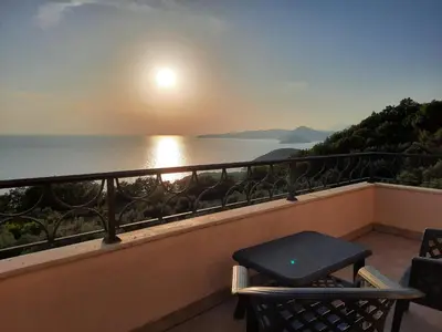 a balcony with a table and a view of the ocean at Villa Lipski in Sveti Stefan