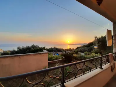 a sunset from the balcony of a house at Villa Lipski in Sveti Stefan